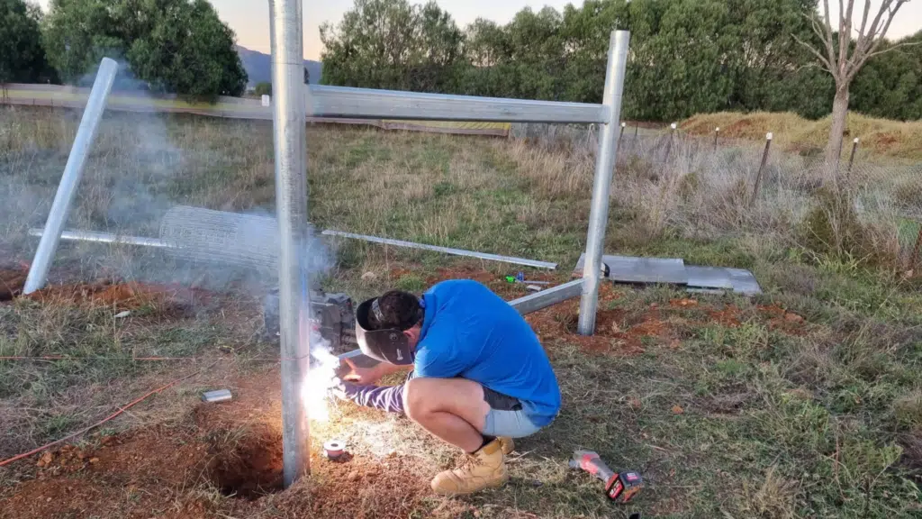 Welding of cattle rail - horse fencing installation - strainer post